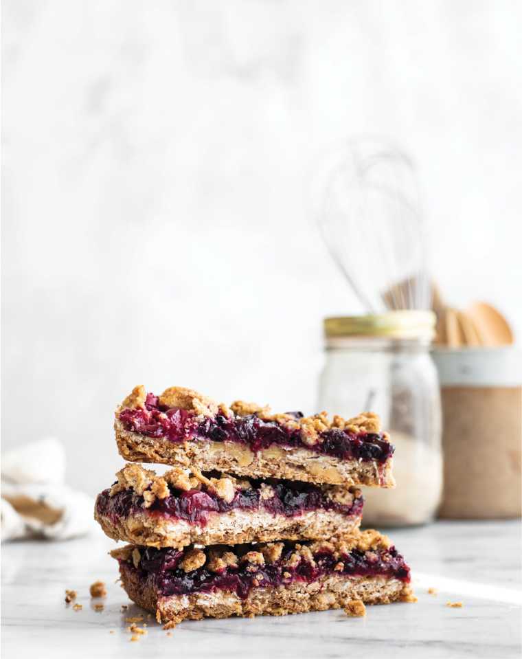 three Vegan Fruit Crumble Bars on top of each other on a table