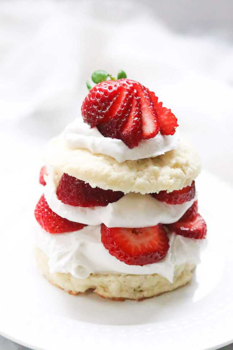 close up of a white plate with a small homemade vegan strawberry shortcake