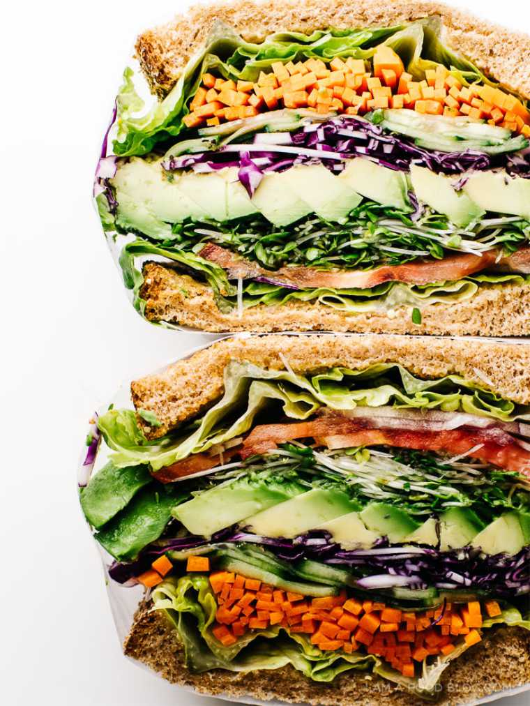 two colorfully stuffed vegan sandwiches on top of each other