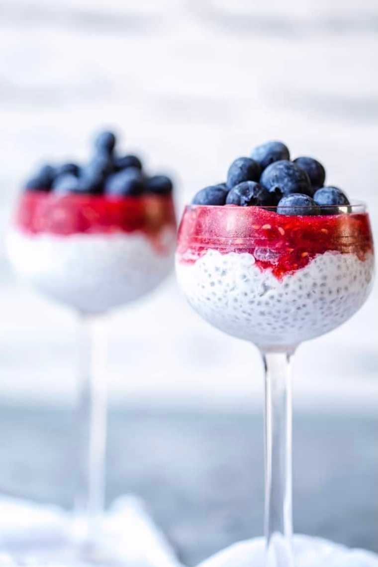 two glasses with vegan chia pudding and two types of berries