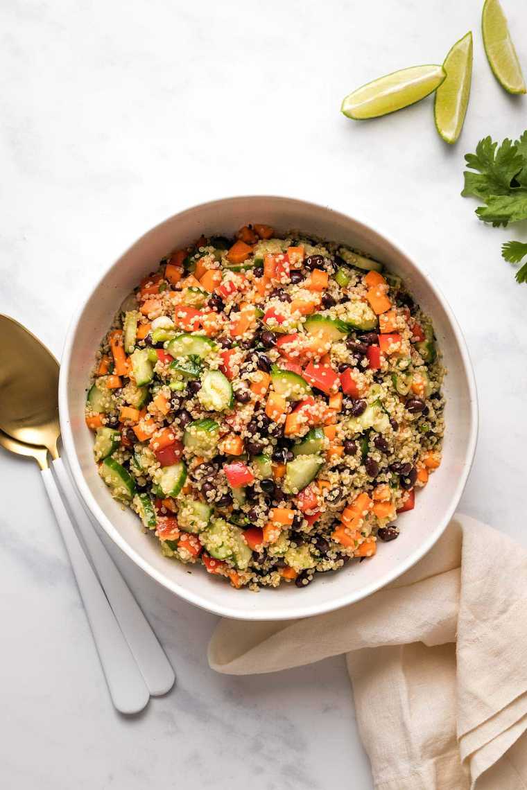 white bowl with quinoa, black bean and veggie salad as a light vegan dinner recipe