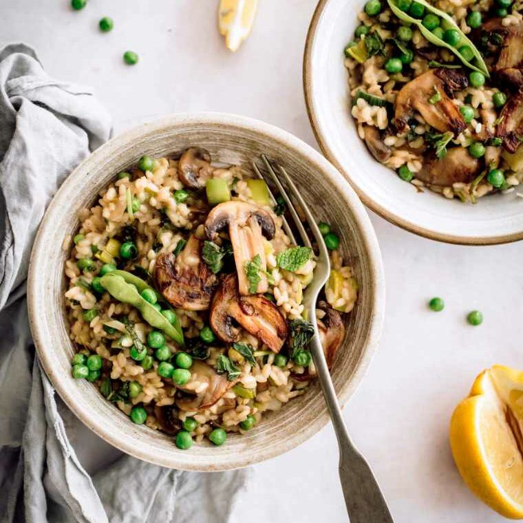two bowls on a table with creamy vegan mushroom risotto
