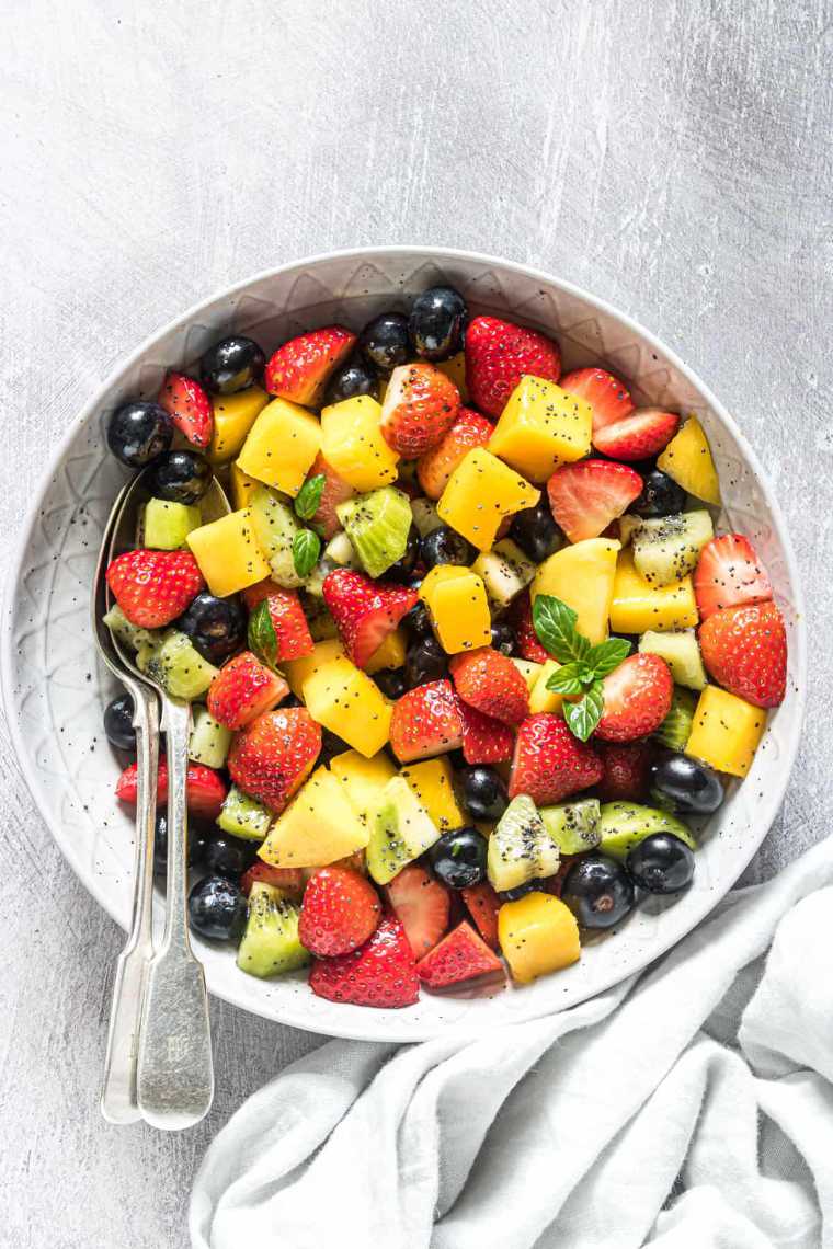 large bowl with easy fruit salad made from strawberries, mango, blueberries and kiwi