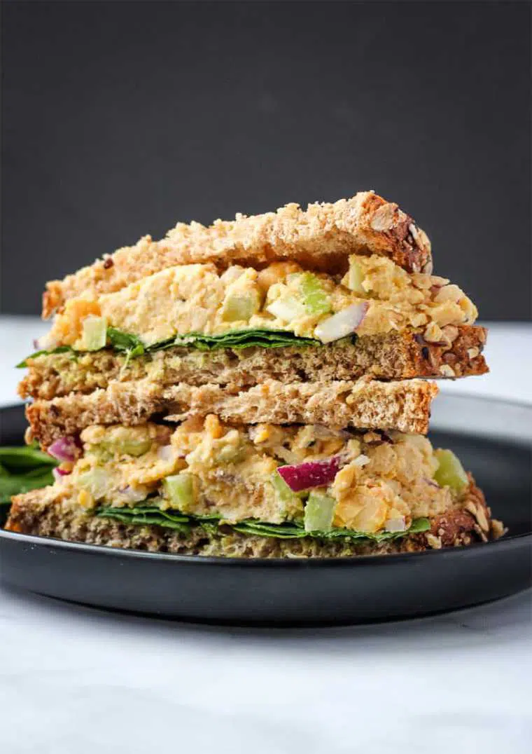 black table with two portable vegan tuna salad sandwiches as cold lunch ideas