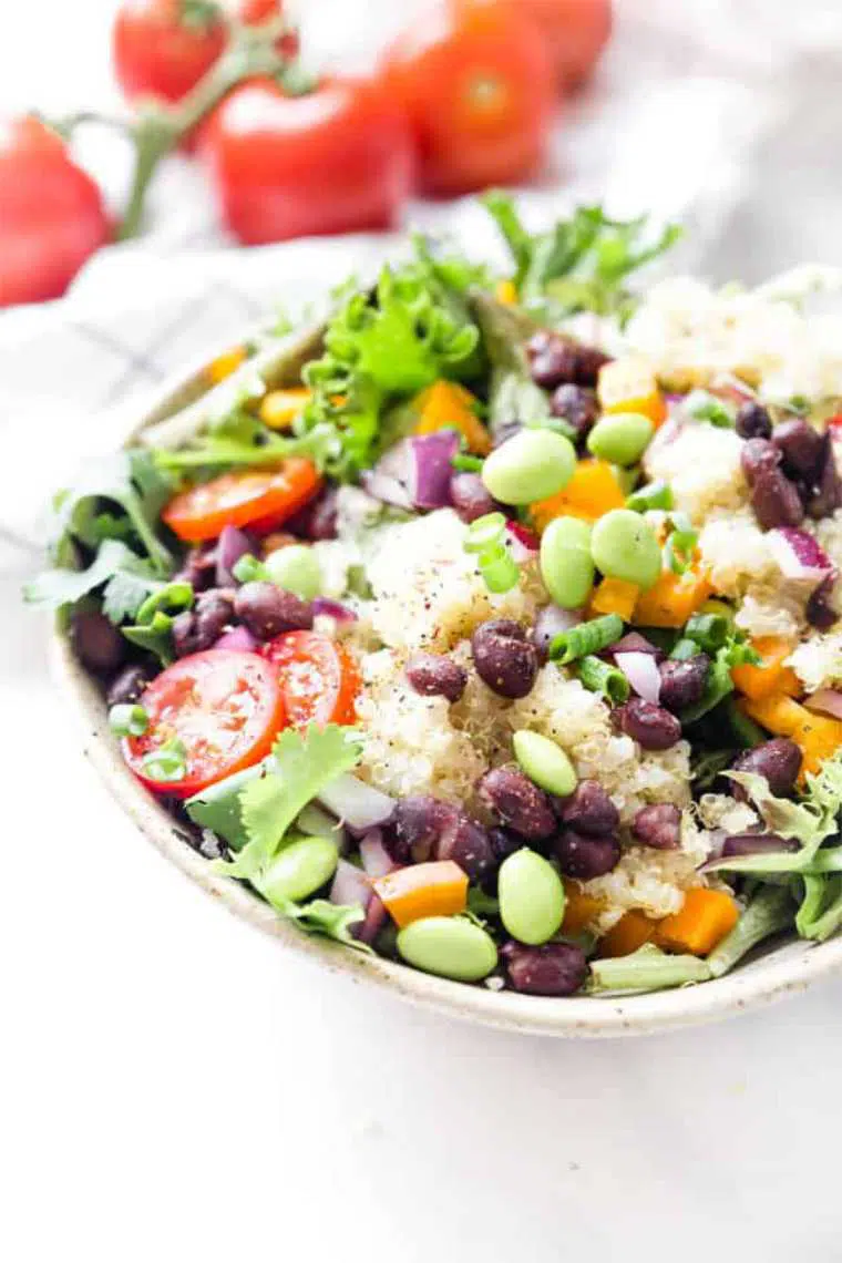 white bowl with black bean, quinoa and edamame salad