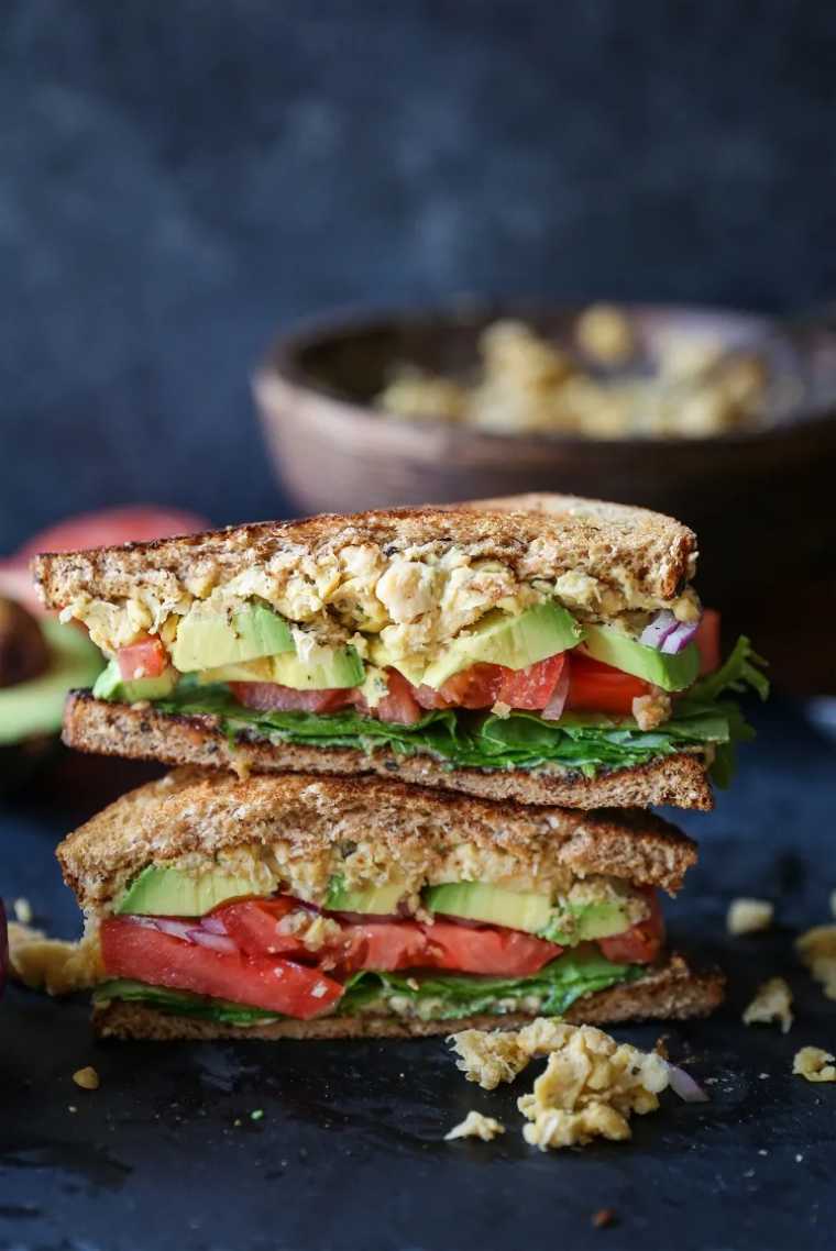 two vegan hummus mashed chickpea sandwiches on top of each other