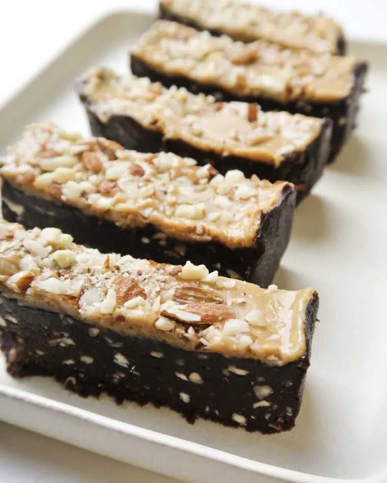 five slices of homemade no-bake vegan brownie peanut butter bars