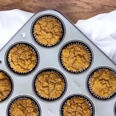 Vegan Pumpkin Muffins in baking dish from the top on a white linen