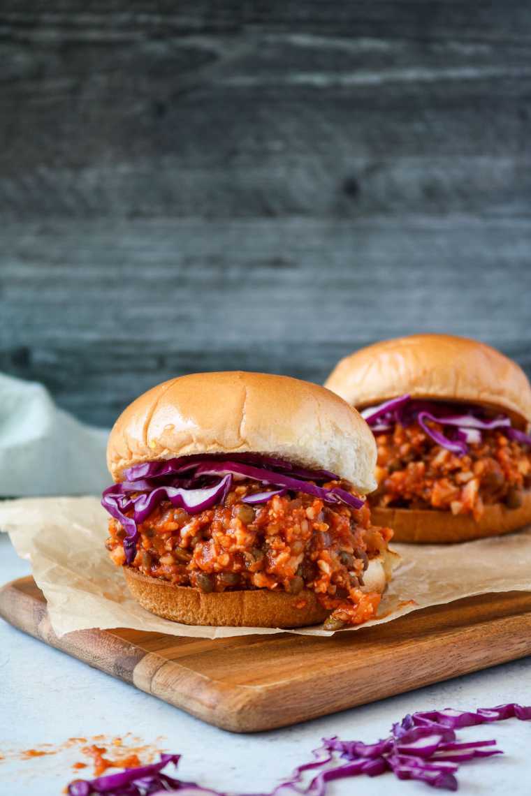 wooden chopping board with two Vegan Sloppy Joes