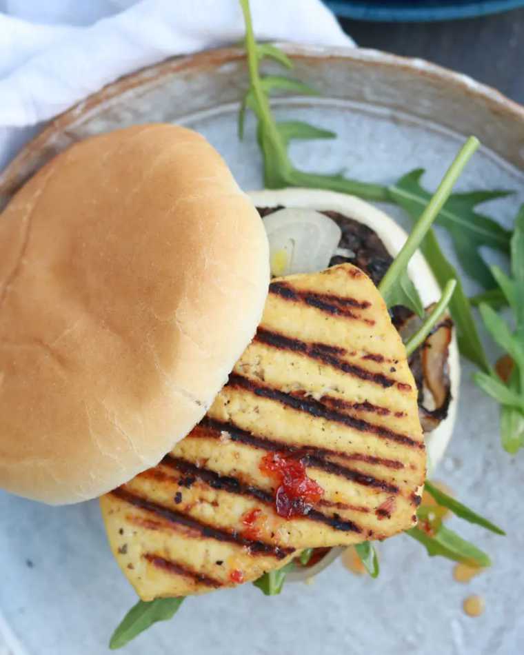 plate with some arugula and a homemade vegan Tofu Halloumi Burger