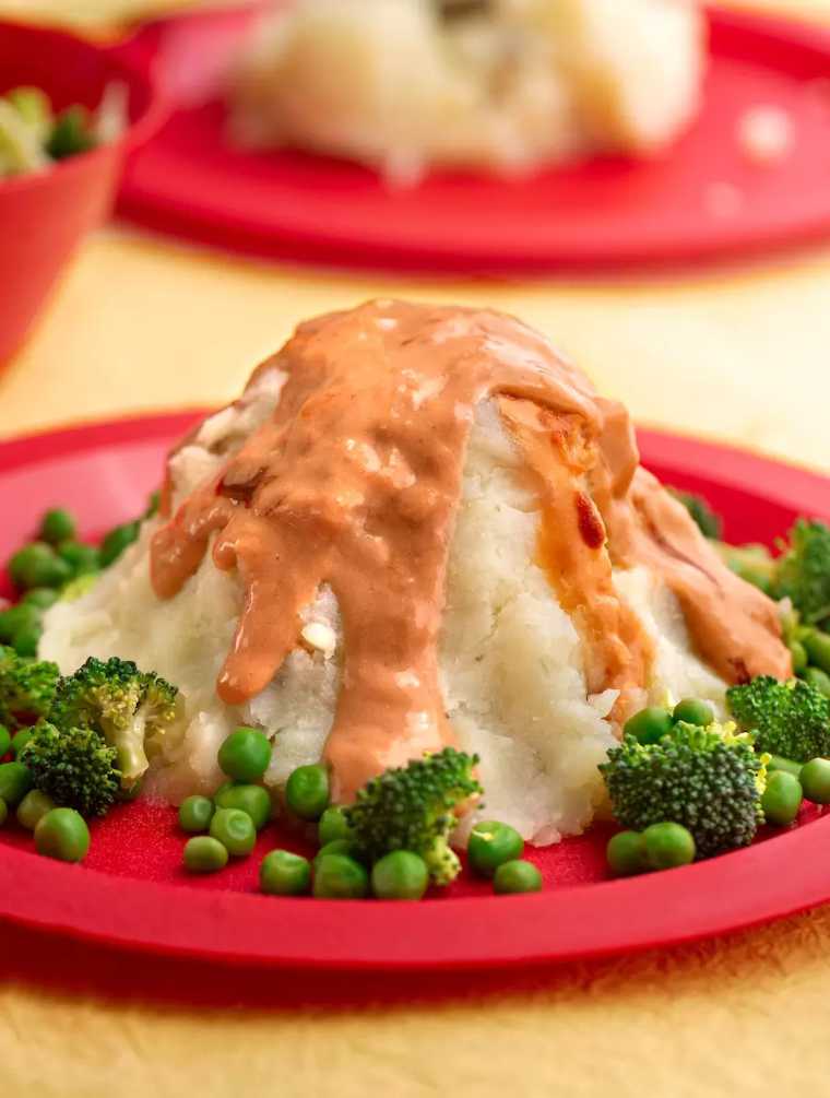 red plate with vegan kid food: broccoli, peas and Vegan potato volcanoes