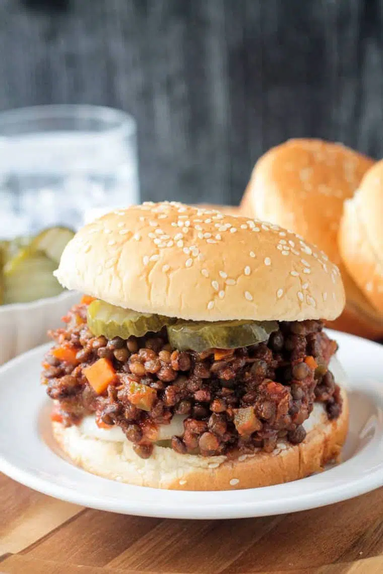 white plate with vegan lentil sloppy joes on a wooden table