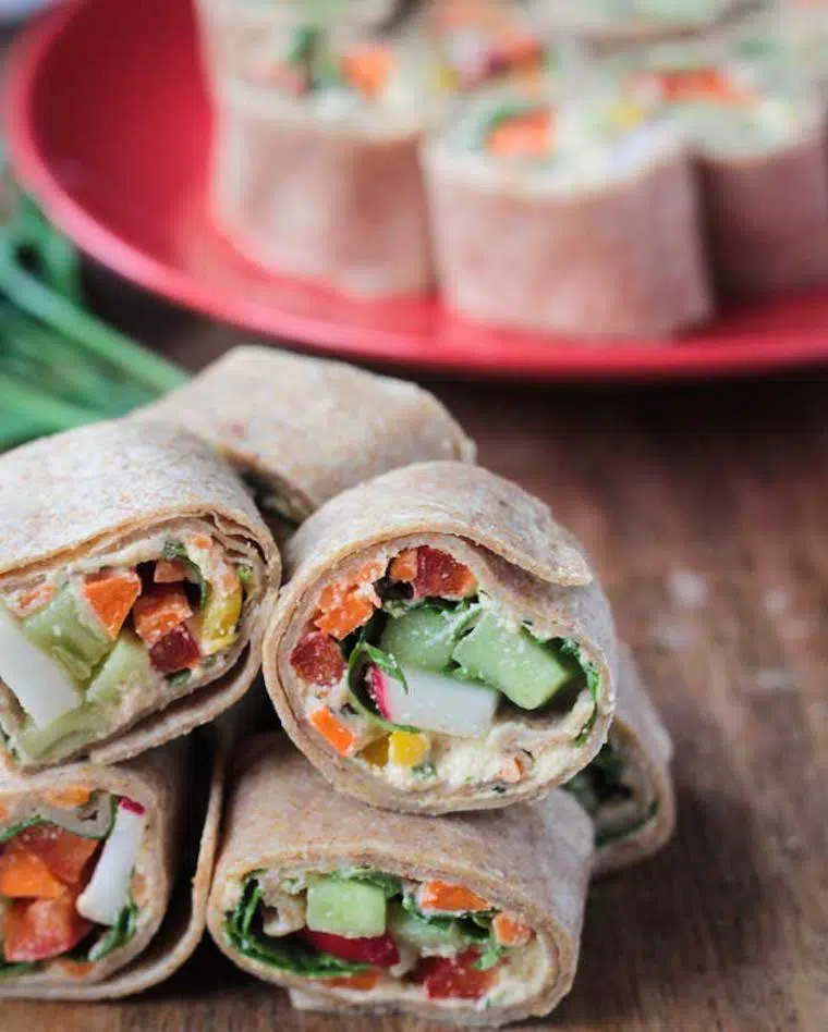 six little whole wheat tortilla rollups filled with veggies next to each other