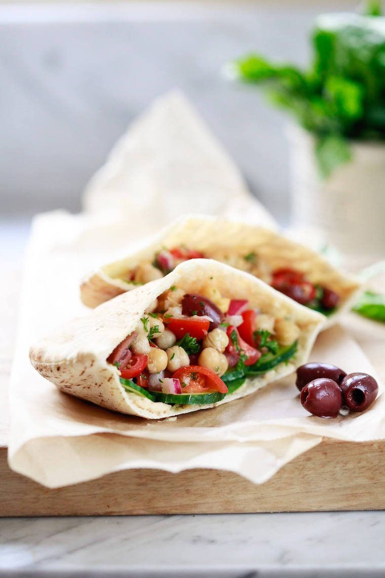 two open pita pockets with middle easter chickpea salad in them