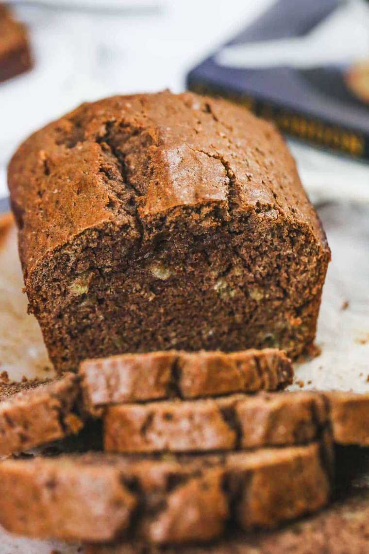 close up of a loaf of vegan chocolate banana bread and a few slices