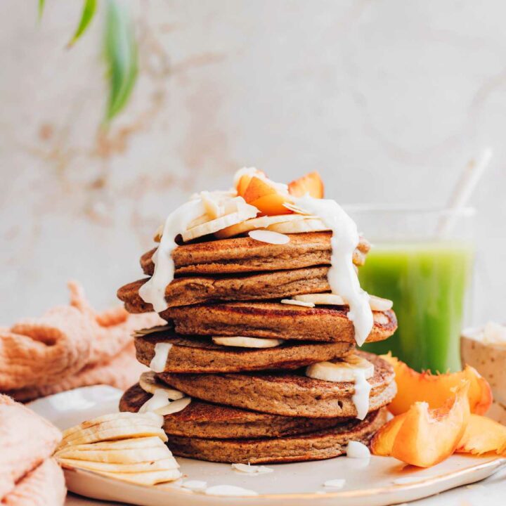 stack of vegan almond pulp pancakes with yogurt and fresh fruit