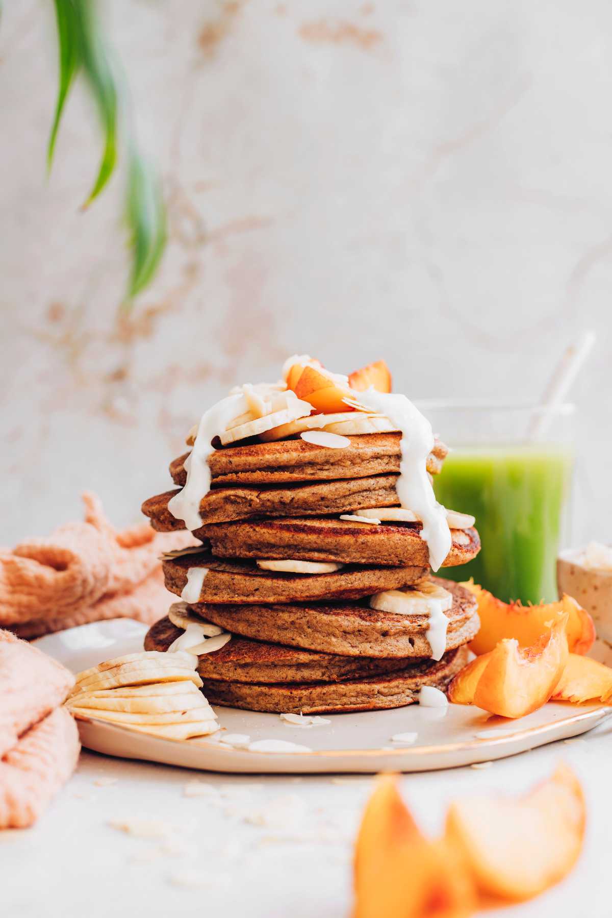 stack of vegan almond pulp pancakes with yogurt and fresh fruit