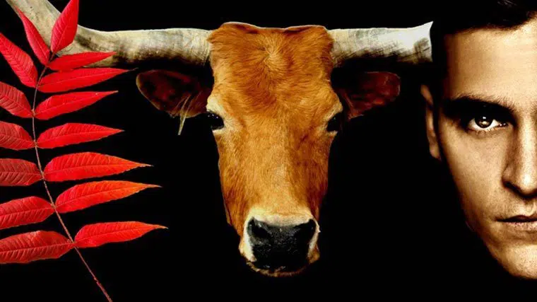 Earthlings film image with branch with red leaves on the left side, an ox in the middle and the face of a man on the right side, isolated on a black background