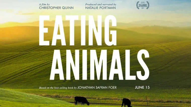 Eating Animals written in large font on a background showing green hills and two cows grazing