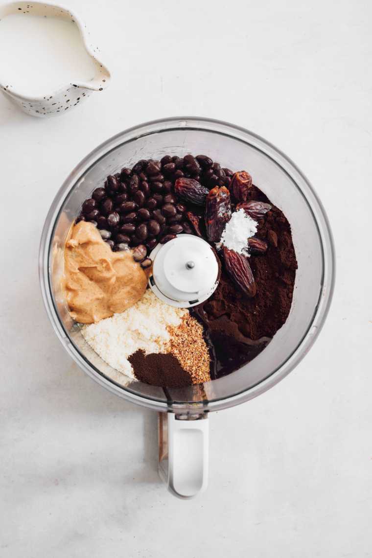 food processor with nut butter, dates, black beans, flour and spices