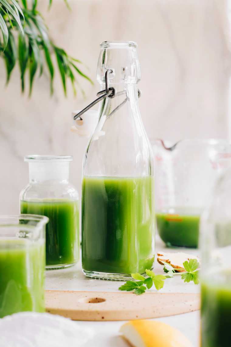 homemade green juice in bottles and glasses