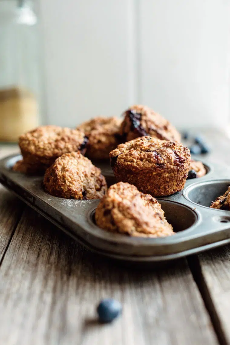 baking dish with freshly baked gluten-free blueberry muffins on a wooden table