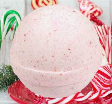 several candy canes on a table with a large pink vegan bath bombs