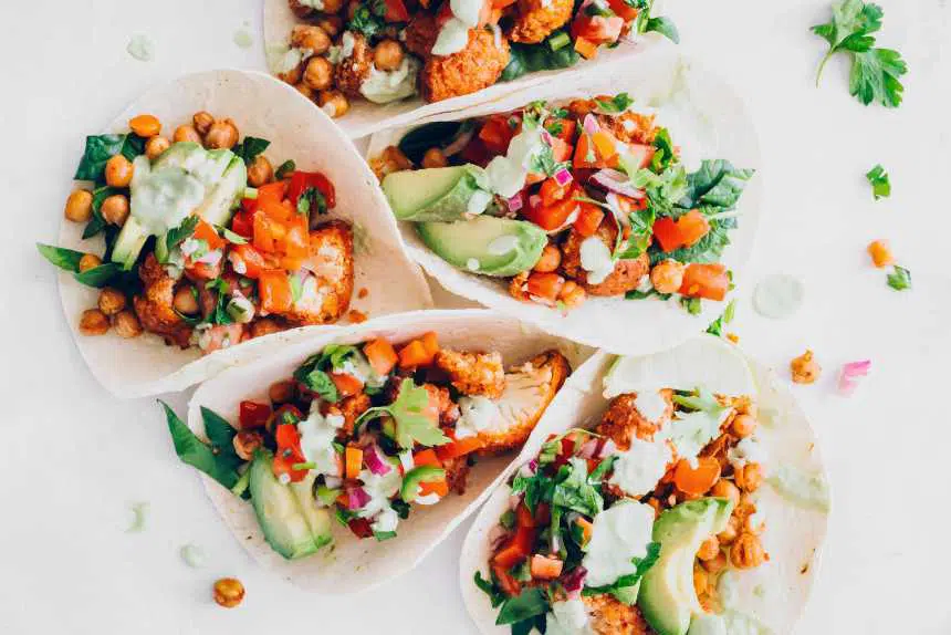 five vegan tacos with chickpeas, spinach, salsa, cauliflower and avocado