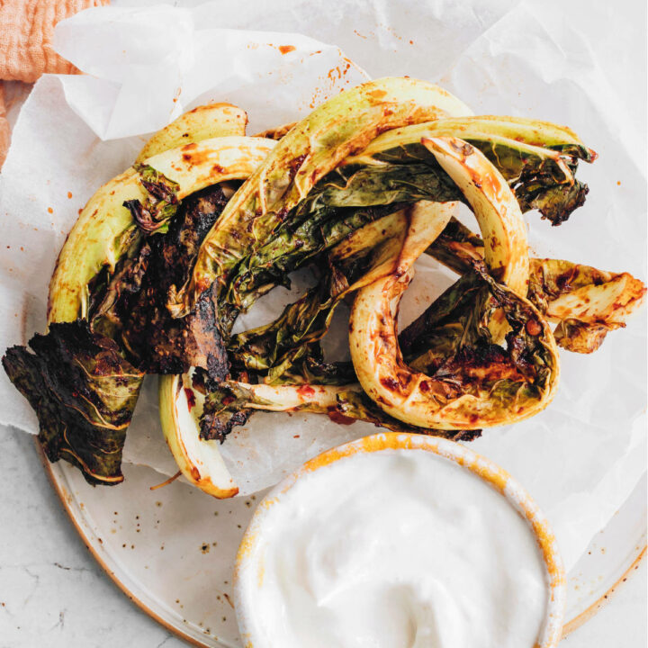 roasted cauliflower leaves with dip on a plate