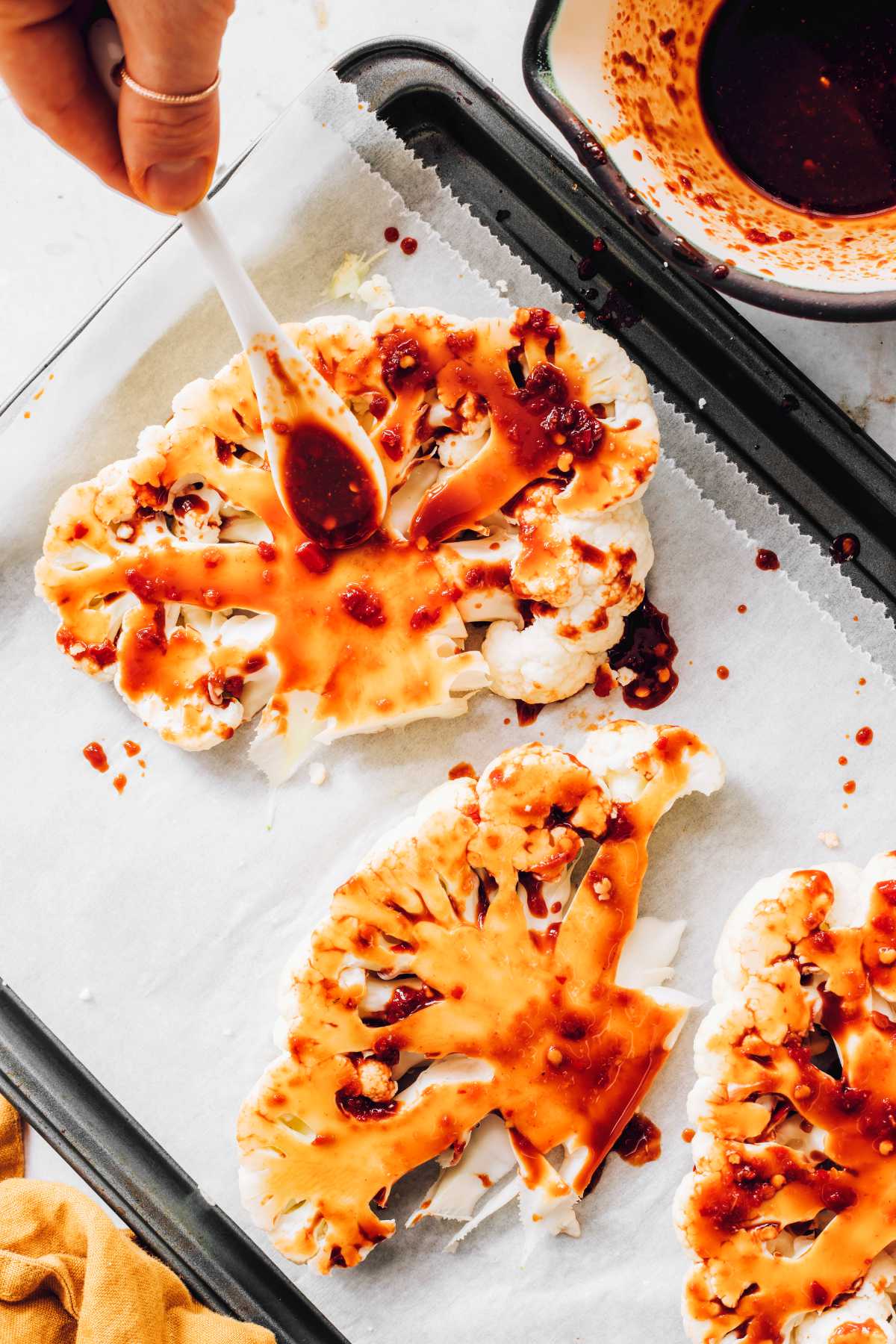 topping cauliflower slices with harissa