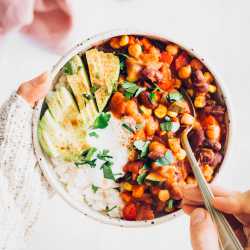 Bowl of vegan chili with rice and avocado