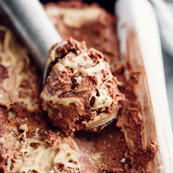 close up of a black baking dish with frozen scooped vegan chocolate peanut butter ice cream