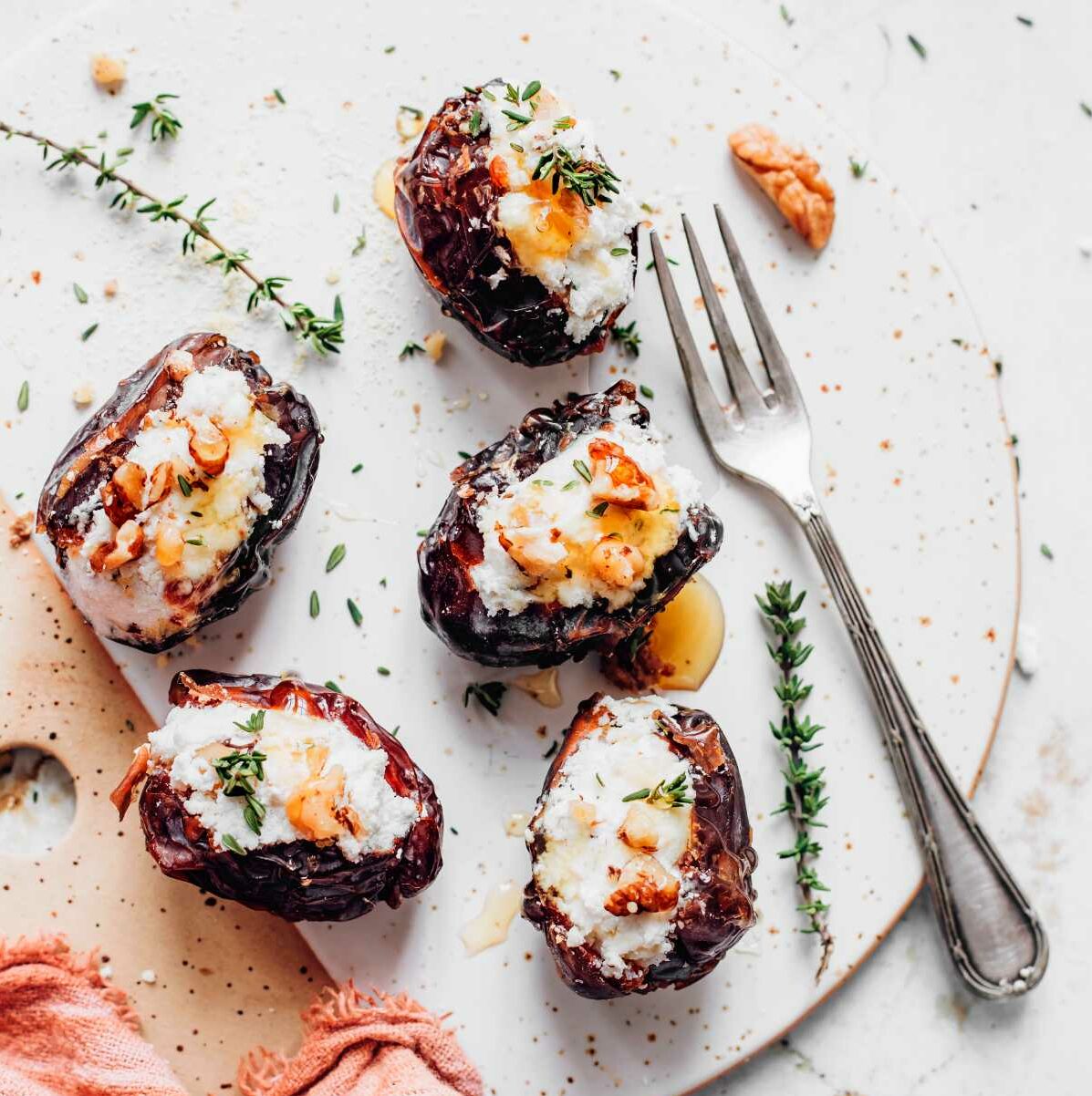 Cream Cheese Stuffed Dates with herbs on a plate
