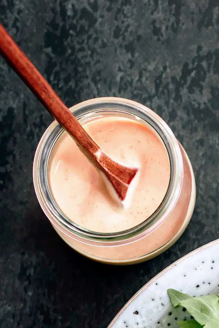 top view of a glass jar with creamy balsamic date dressing