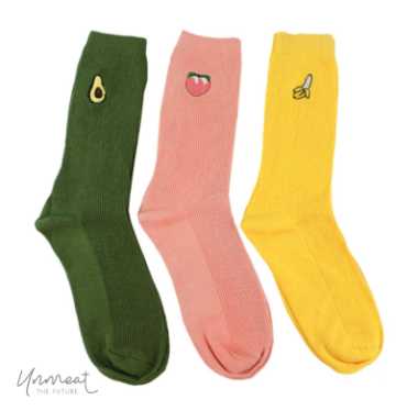 three individual colorful socks in green, apricot and yellow next to each other