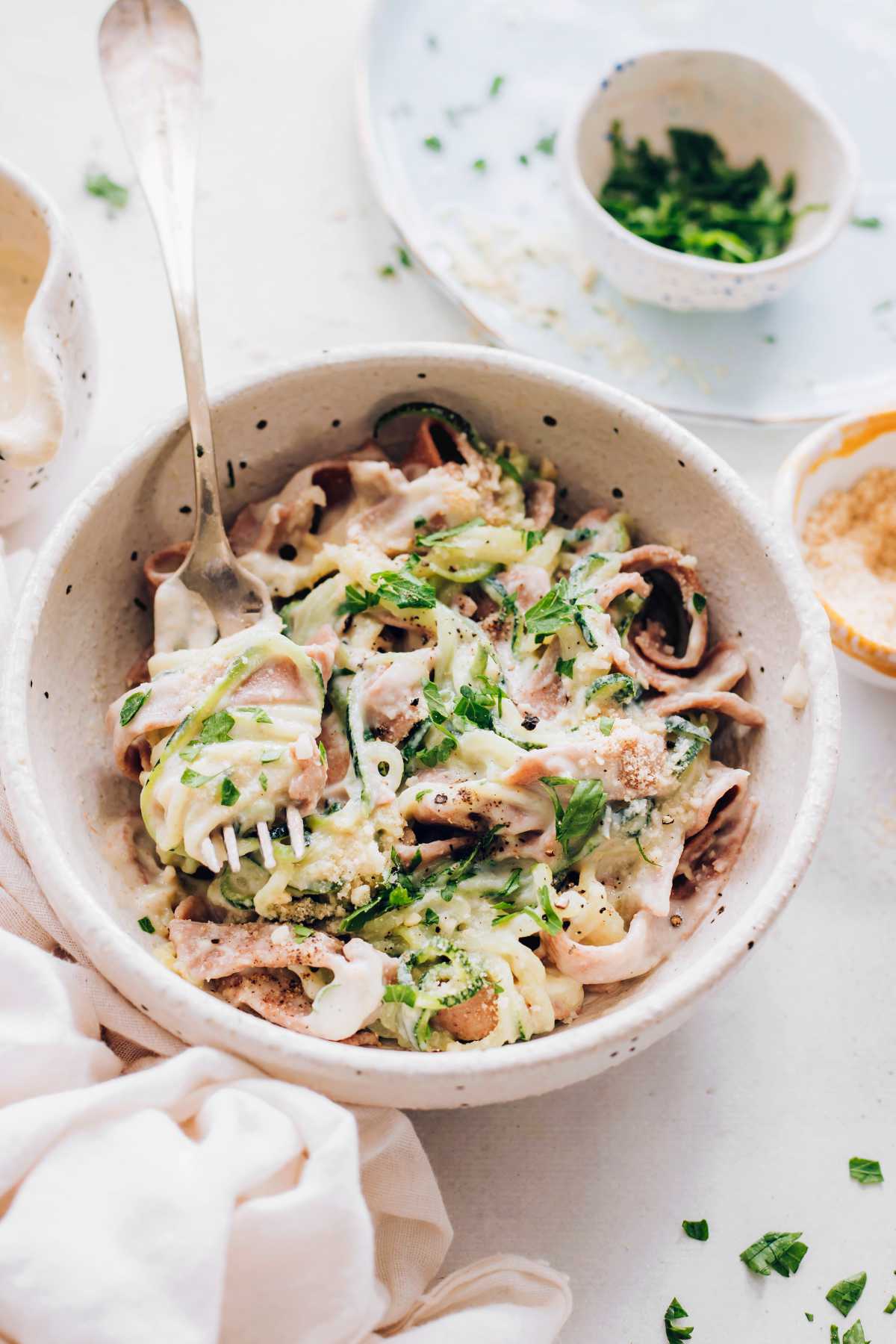 Vegan Fettuccine Alfredo in a bowl with a fork