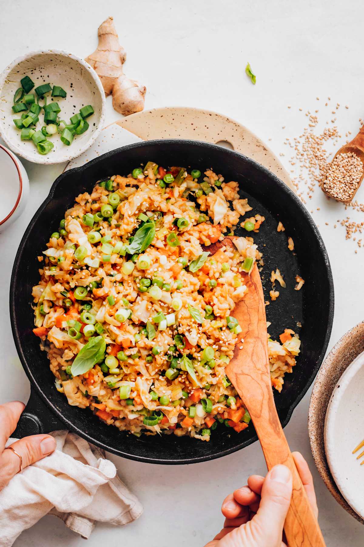 stirring rice and veggies in a pan