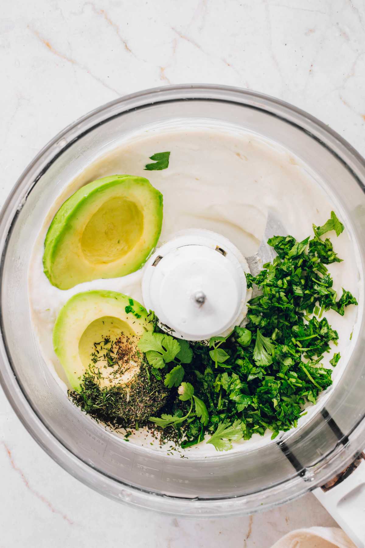 avocado, tofu, and herbs in a blender