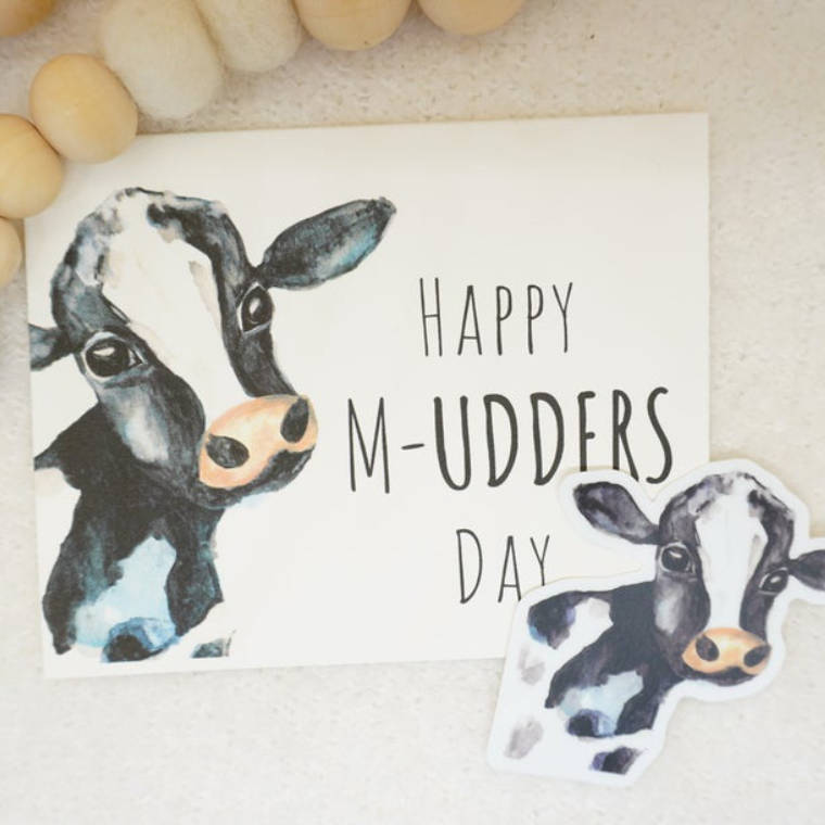 white card with watercolored calves and the words "happy m-udders day"