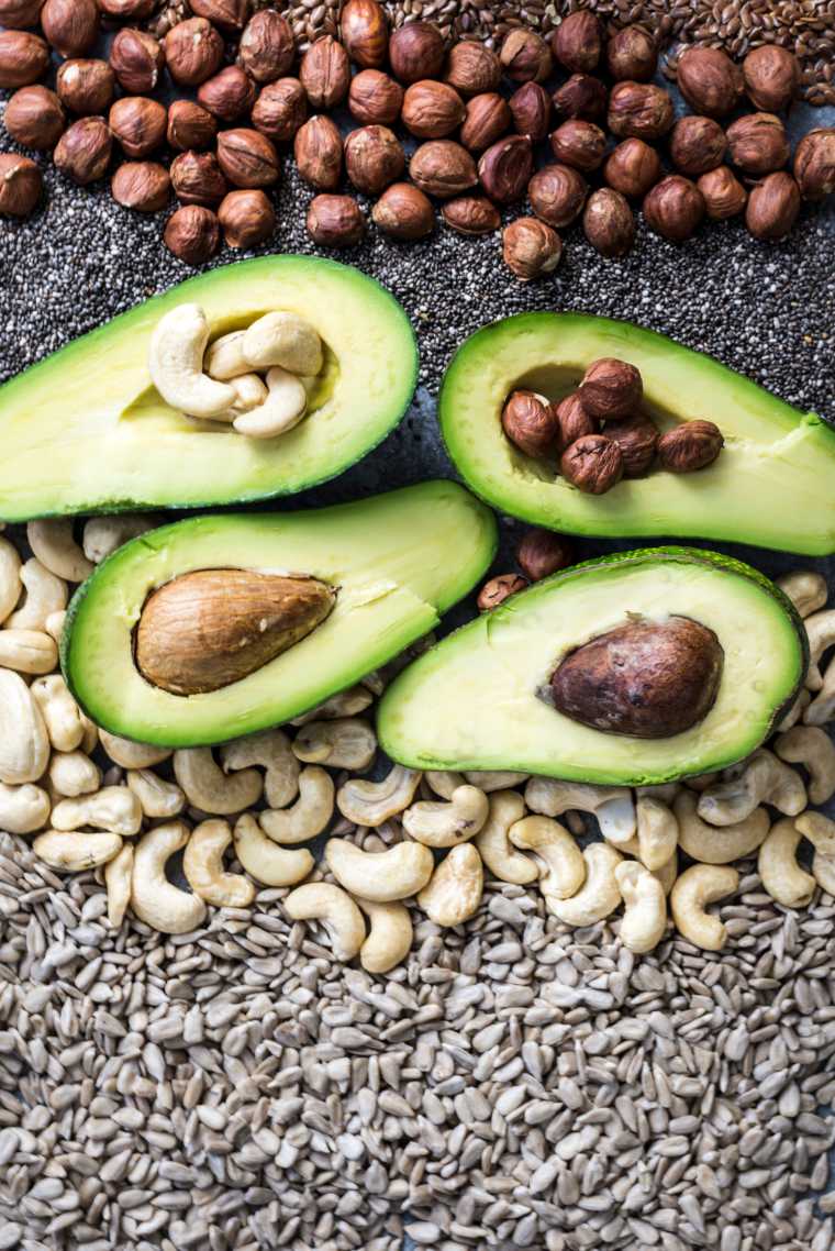 avocados, nuts and seeds on a table