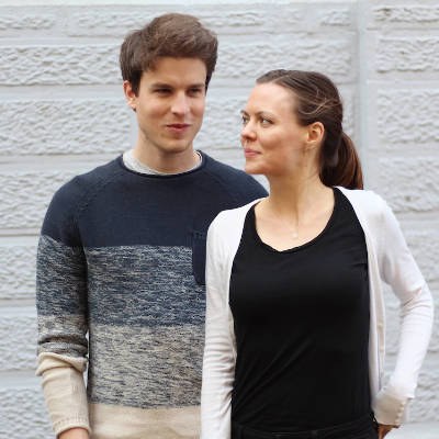 Lars and Alena, the couple behind and creators of the website nutriciously, in front of a stone wall