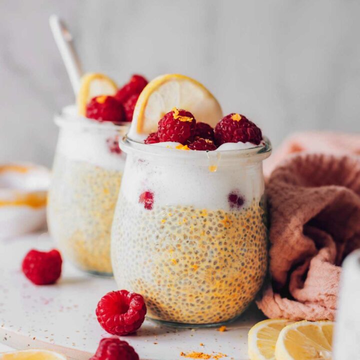 two glasses of raspberry lemon chia pudding on a table