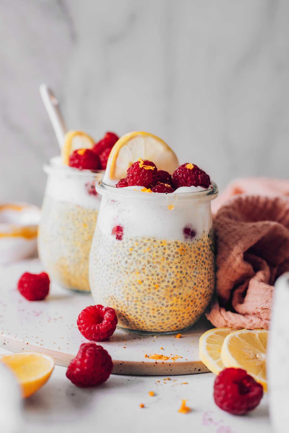 two glasses of raspberry lemon chia pudding on a table