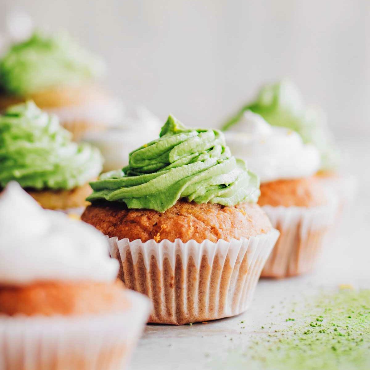 vegan matcha cupcakes and lemon cupcakes on a table