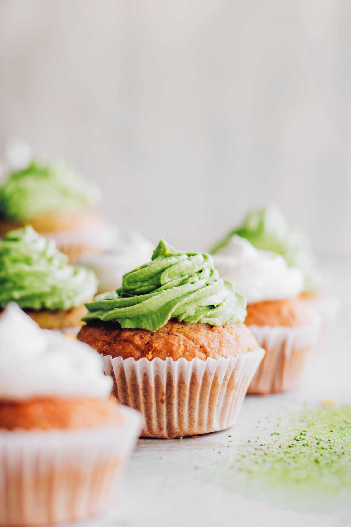 vegan matcha cupcakes and lemon cupcakes on a table