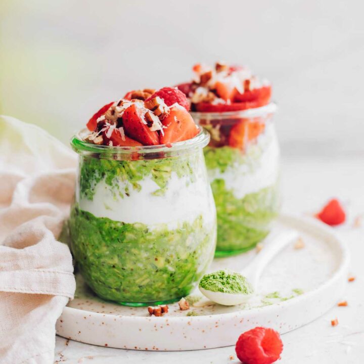 two jars of homemade matcha overnight oats with berries