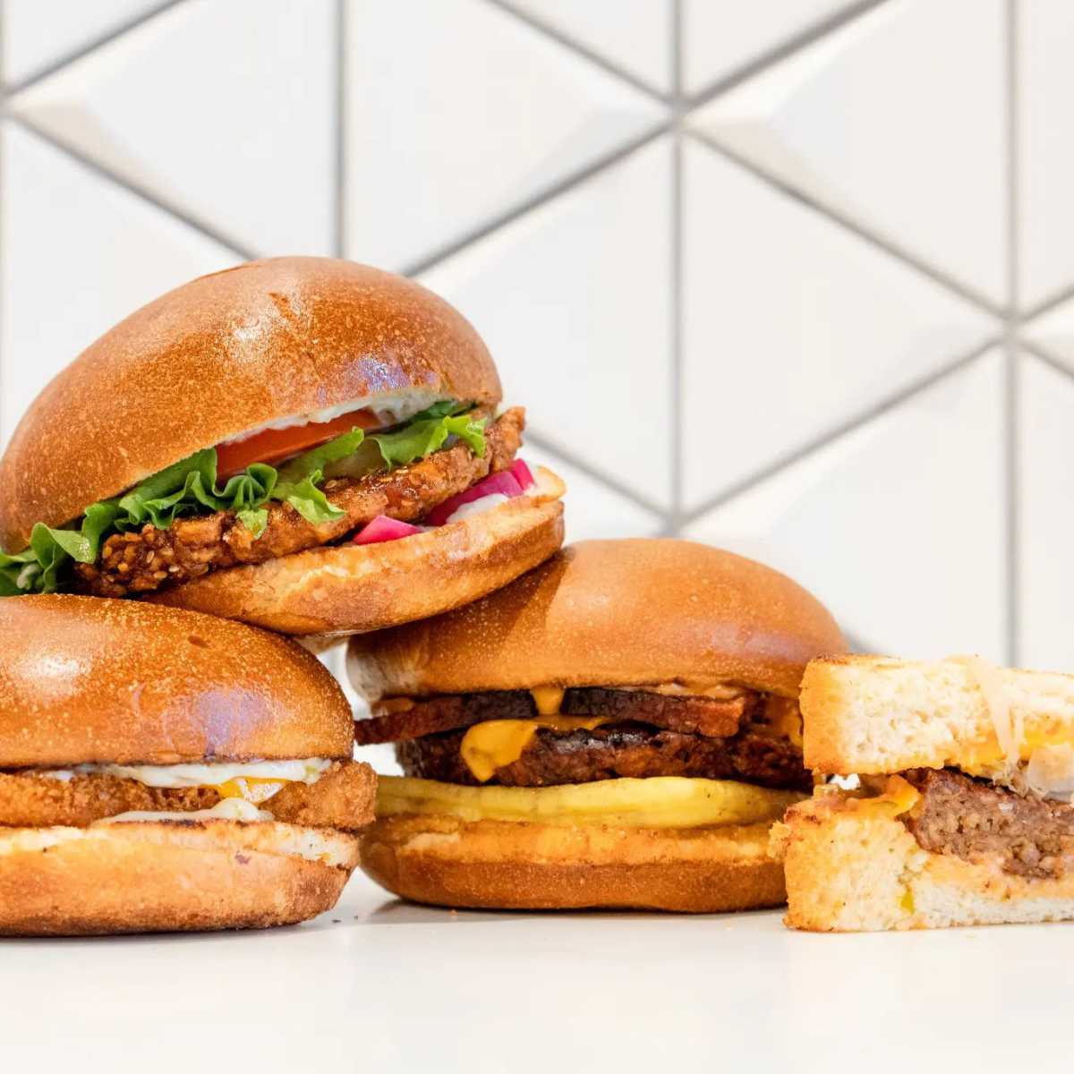 three vegan burgers on a table
