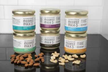 Six glass jars of Modest Mylk base for plant-based milks