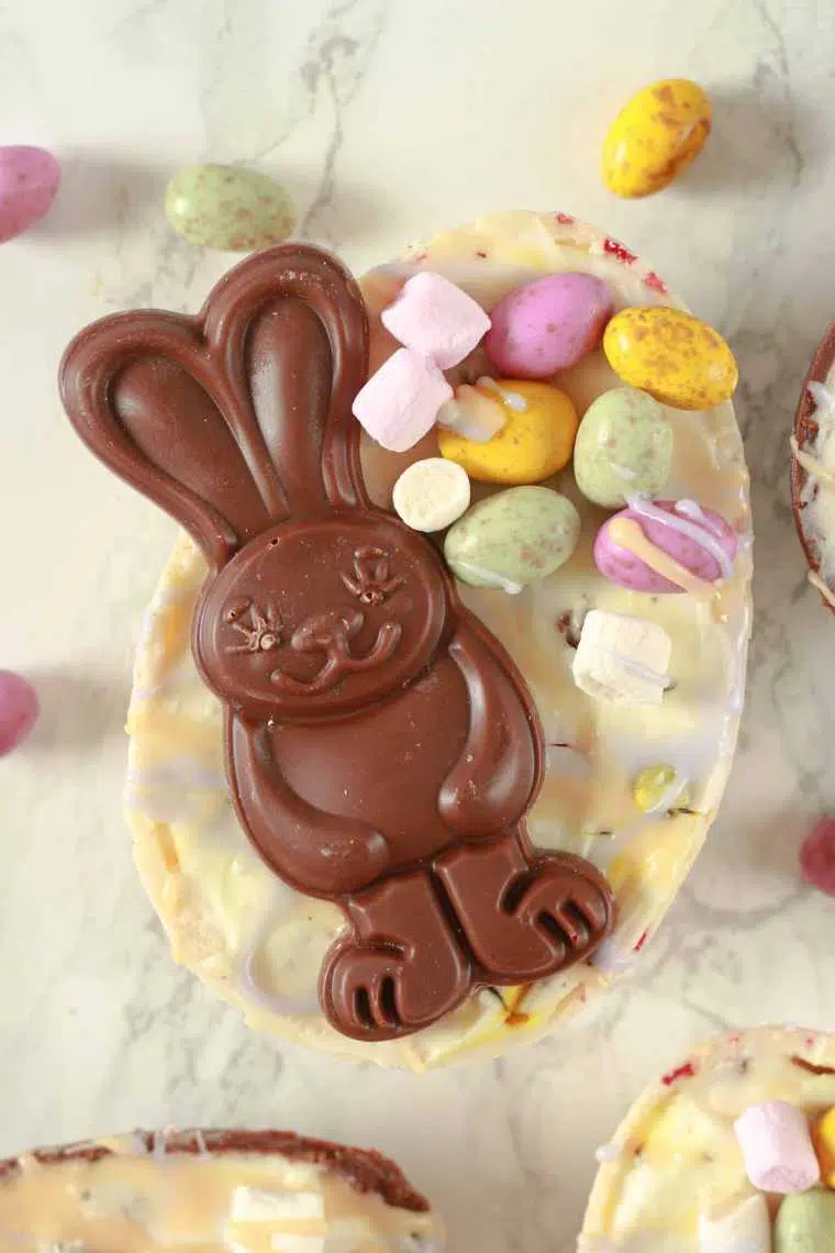 homemade vegan cheesecake Easter egg decorated with a chocolate bunny