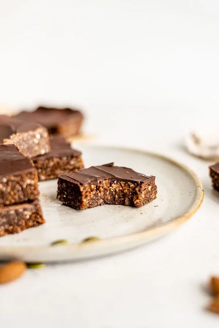 plate with several homemade no bake energy bars for a vegan high-protein post-workout snack